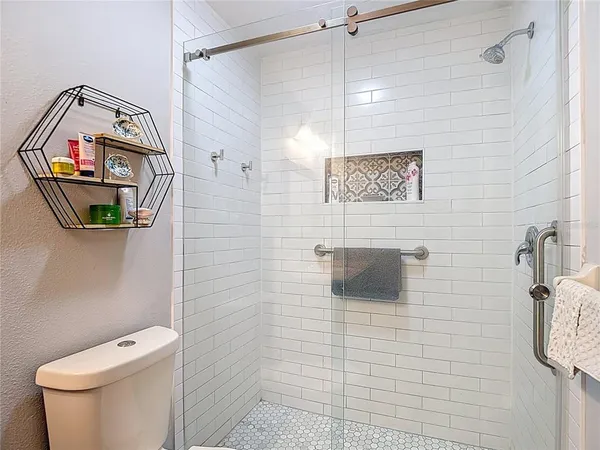 a view of a hallway with wooden floor and closet area