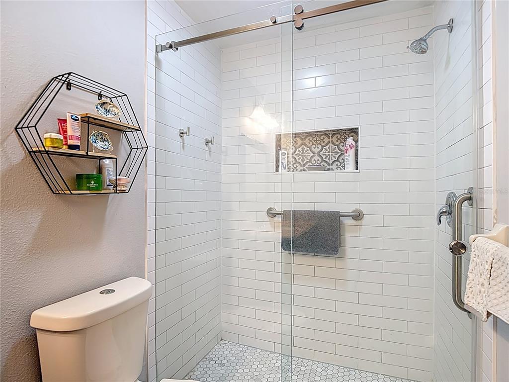 7828 Hardwick Drive, Unit 916 New Port Richey, FL 34653 - Photo 28 of 40 a bathroom with a toilet and a shower
