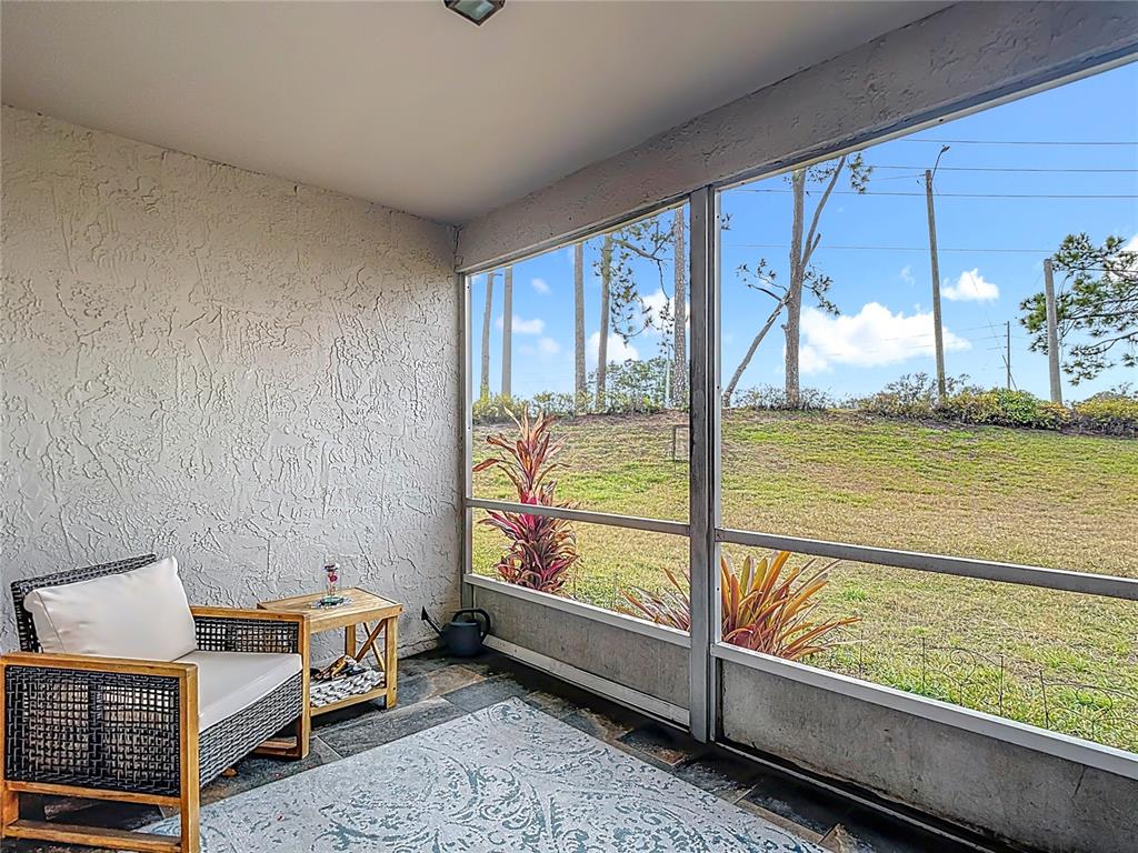 7828 Hardwick Drive, Unit 916 New Port Richey, FL 34653 - Photo 32 of 40 a bedroom with furniture and large windows