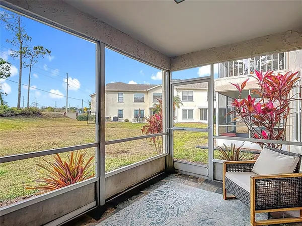 a view of a house with a yard and sitting area