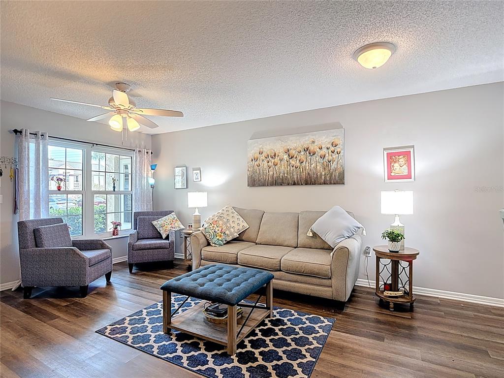 7828 Hardwick Drive, Unit 916 New Port Richey, FL 34653 - Photo 4 of 40 a living room with furniture and wooden floor