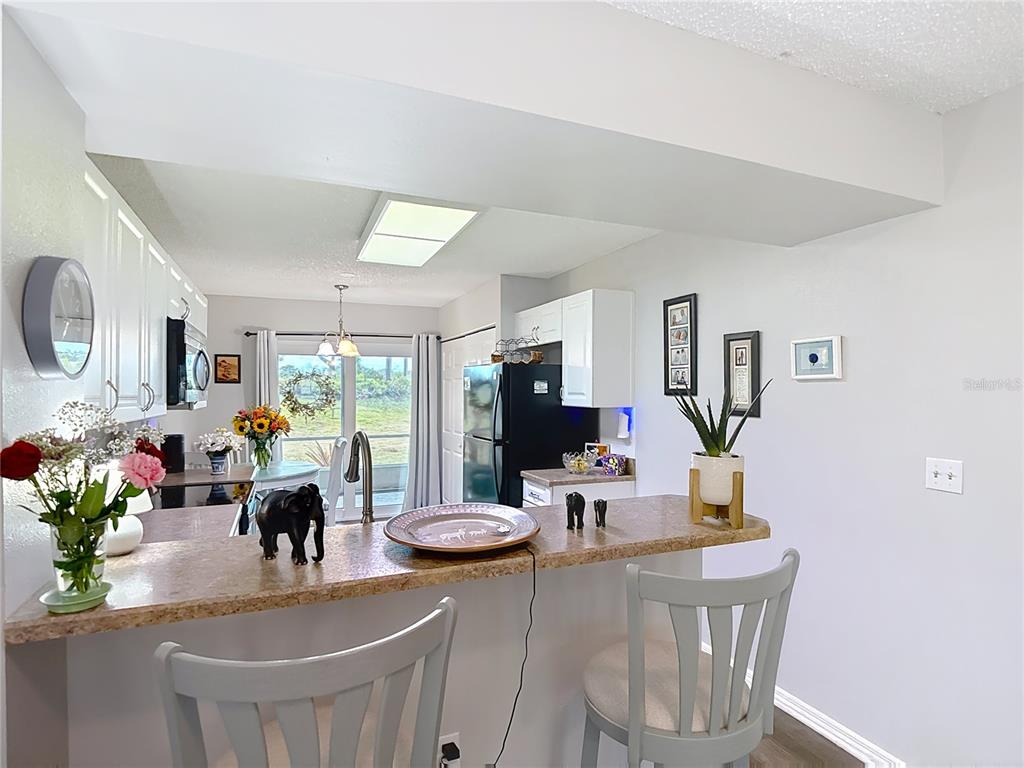 7828 Hardwick Drive, Unit 916 New Port Richey, FL 34653 - Photo 7 of 40 a view of a dining room with furniture window and outside view