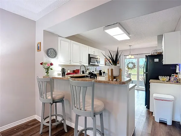 a kitchen with a sink and a refrigerator