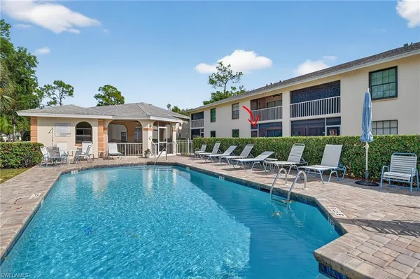 a view of a house with swimming pool and sitting area