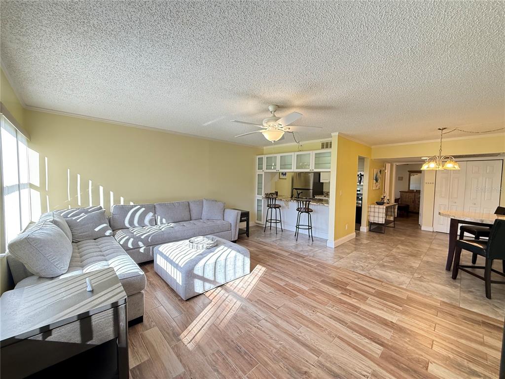 12200 Vonn Road, Unit 2105 Largo, FL 33774 - Photo 12 of 37 a living room with furniture and a wooden floor