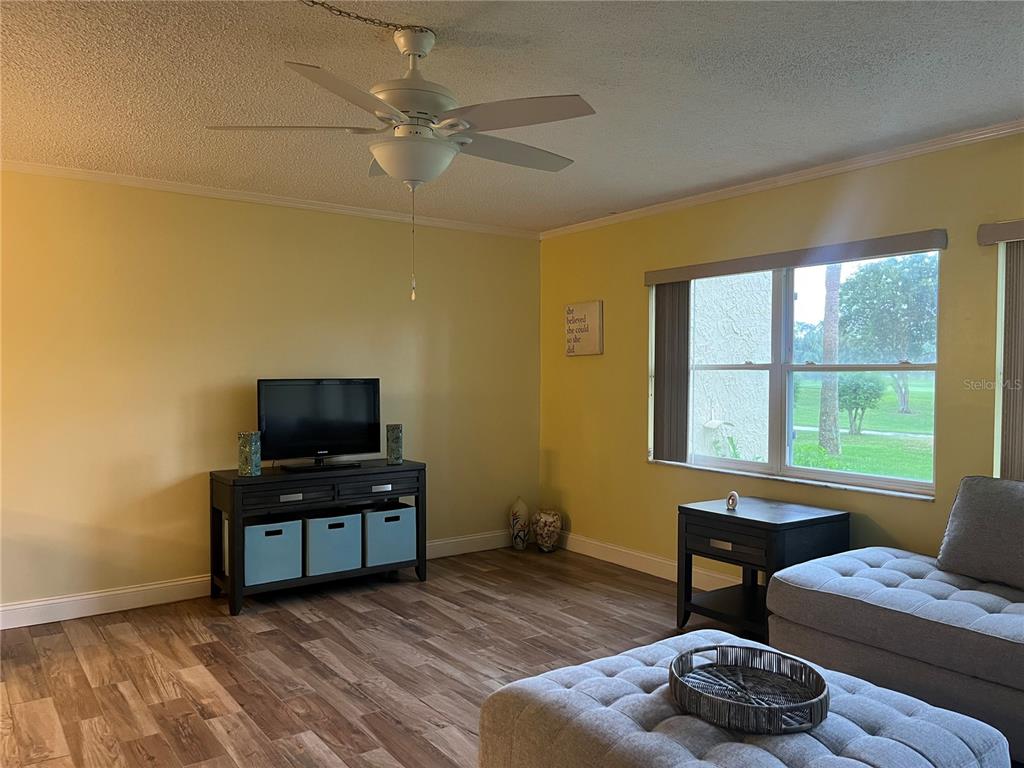 12200 Vonn Road, Unit 2105 Largo, FL 33774 - Photo 13 of 37 a living room with furniture and a flat screen tv