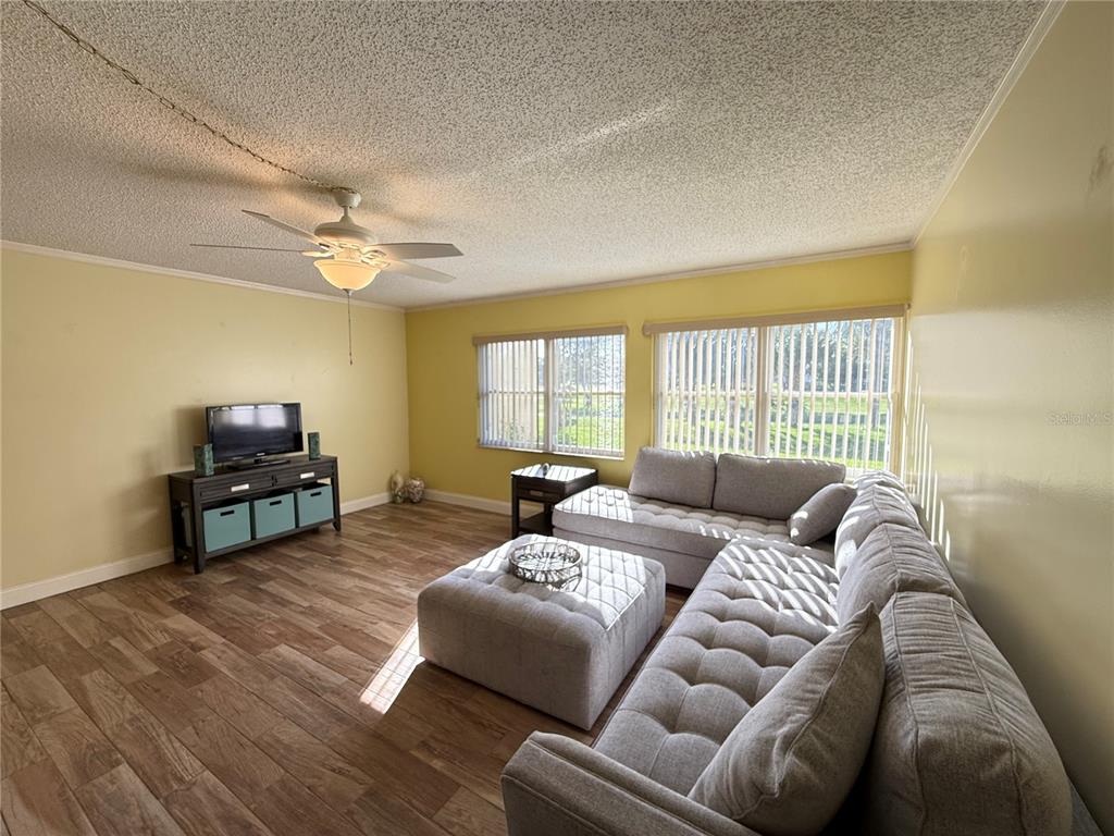 12200 Vonn Road, Unit 2105 Largo, FL 33774 - Photo 15 of 37 a living room with furniture and a flat screen tv