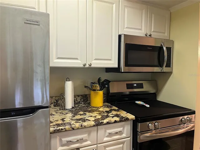 a kitchen with a stove and a microwave