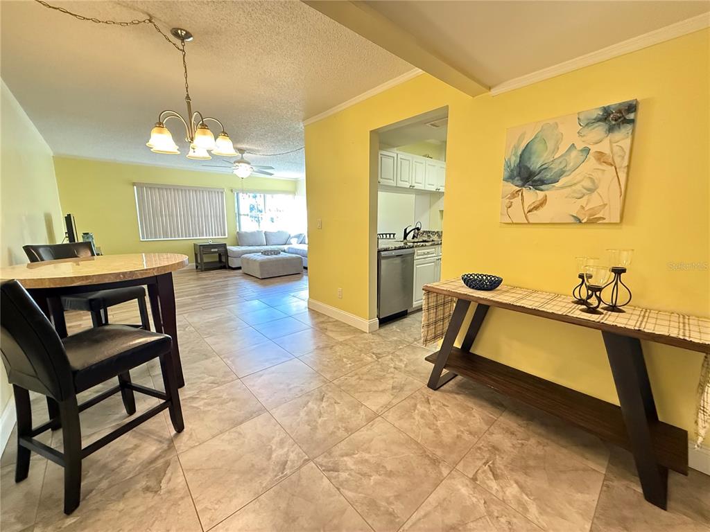 12200 Vonn Road, Unit 2105 Largo, FL 33774 - Photo 2 of 37 a room with table chairs and a chandelier