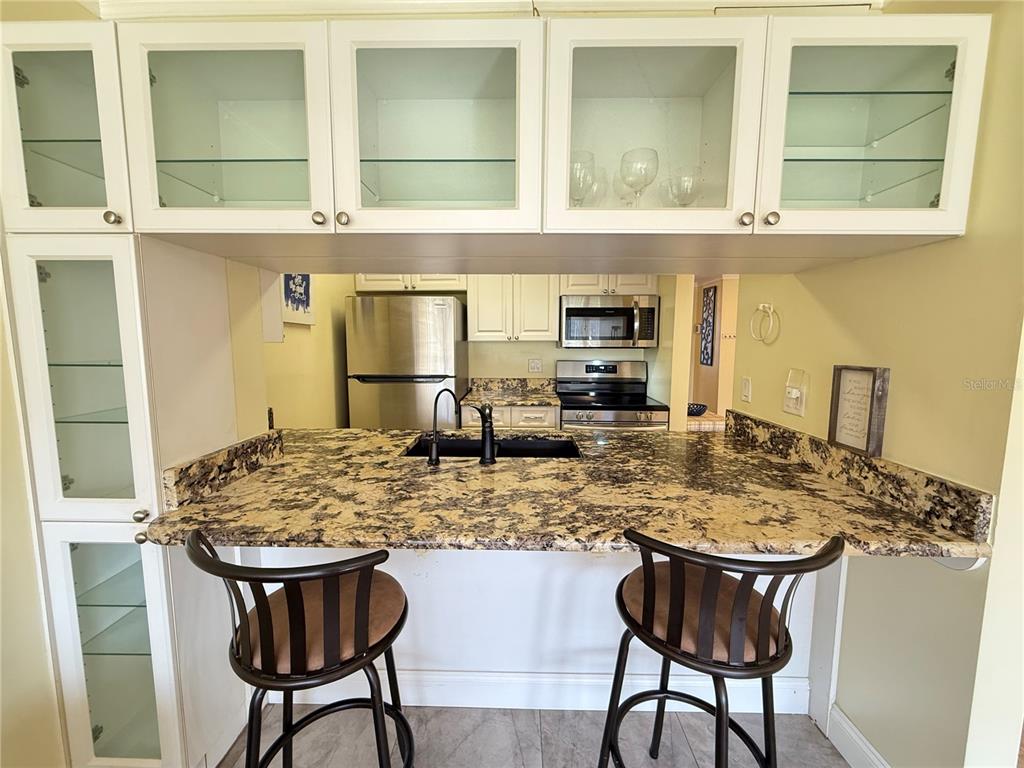 12200 Vonn Road, Unit 2105 Largo, FL 33774 - Photo 23 of 37 a kitchen with a table and chairs in it