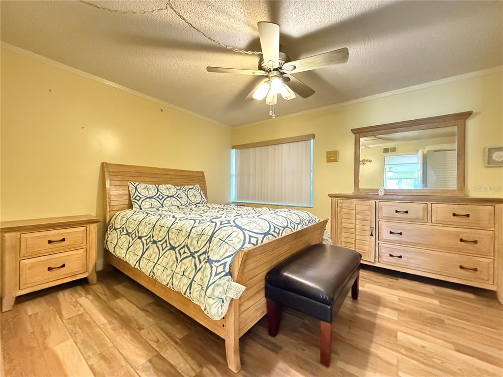 12200 Vonn Road, Unit 2105 Largo, FL 33774 - Photo 24 of 37 a bedroom with a bed and a dresser