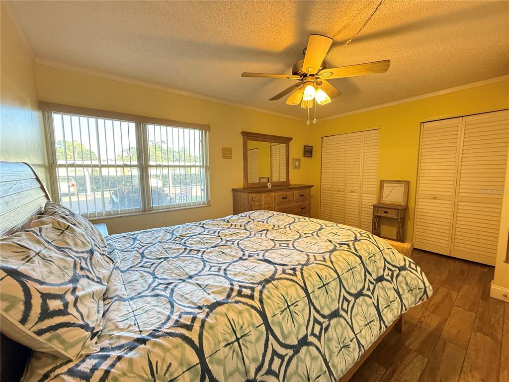 12200 Vonn Road, Unit 2105 Largo, FL 33774 - Photo 25 of 37 a bedroom with a bed and a chandelier