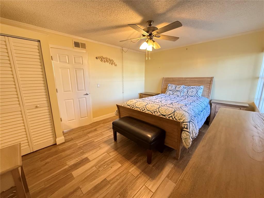 12200 Vonn Road, Unit 2105 Largo, FL 33774 - Photo 27 of 37 a bedroom with a bed and wooden floor
