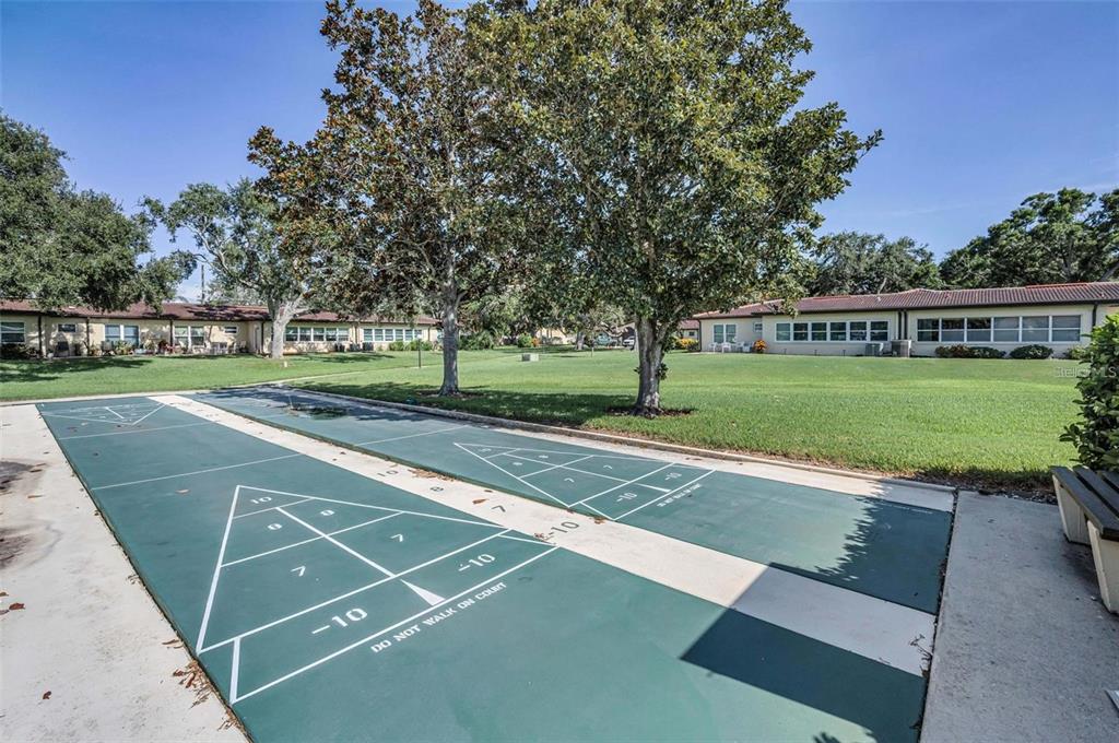 12200 Vonn Road, Unit 2105 Largo, FL 33774 - Photo 33 of 37 a view of a tennis ground with a large trees
