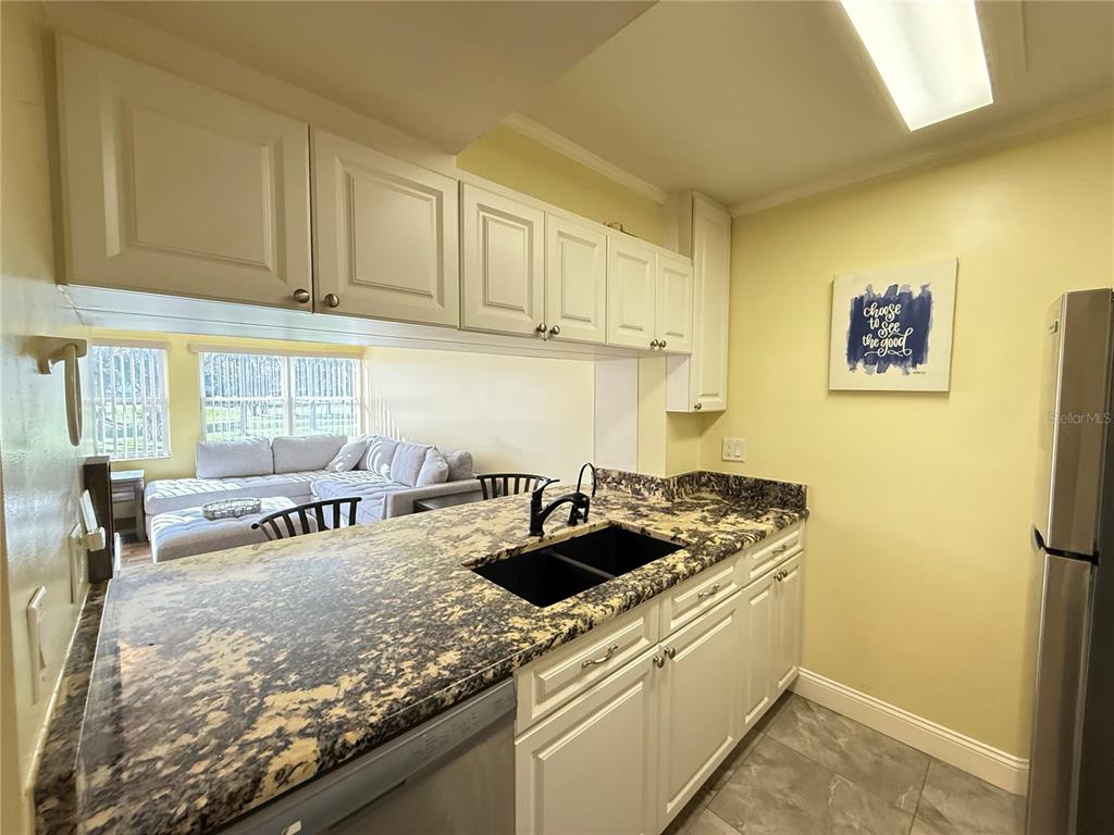 12200 Vonn Road, Unit 2105 Largo, FL 33774 - Photo 4 of 37 a kitchen with stainless steel appliances granite countertop a sink and cabinets