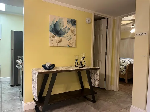 a room with a table and a refrigerator