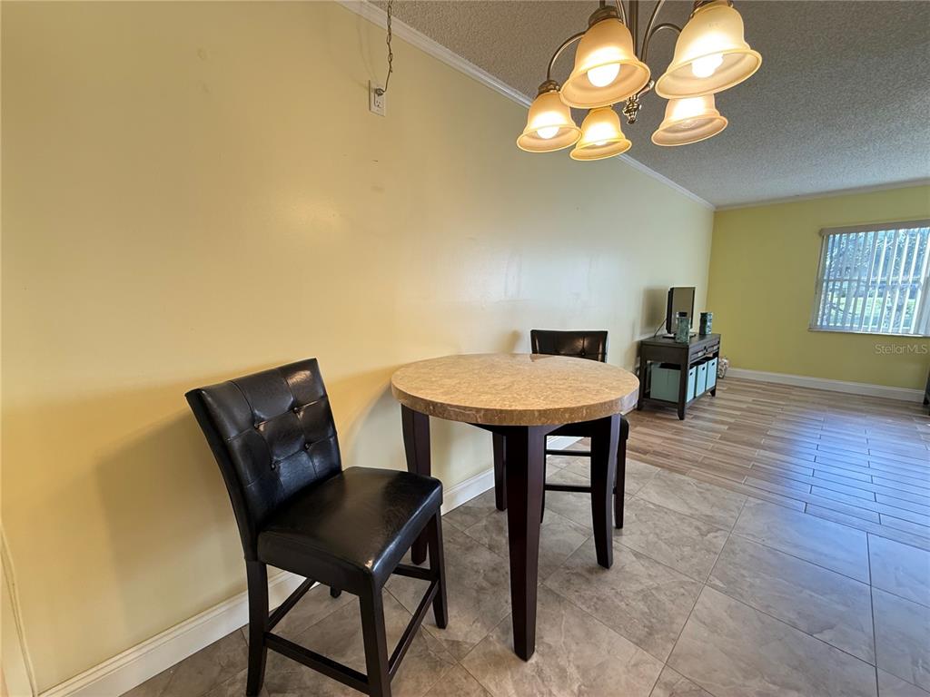 12200 Vonn Road, Unit 2105 Largo, FL 33774 - Photo 9 of 37 a view of a dining room with furniture and wooden floor
