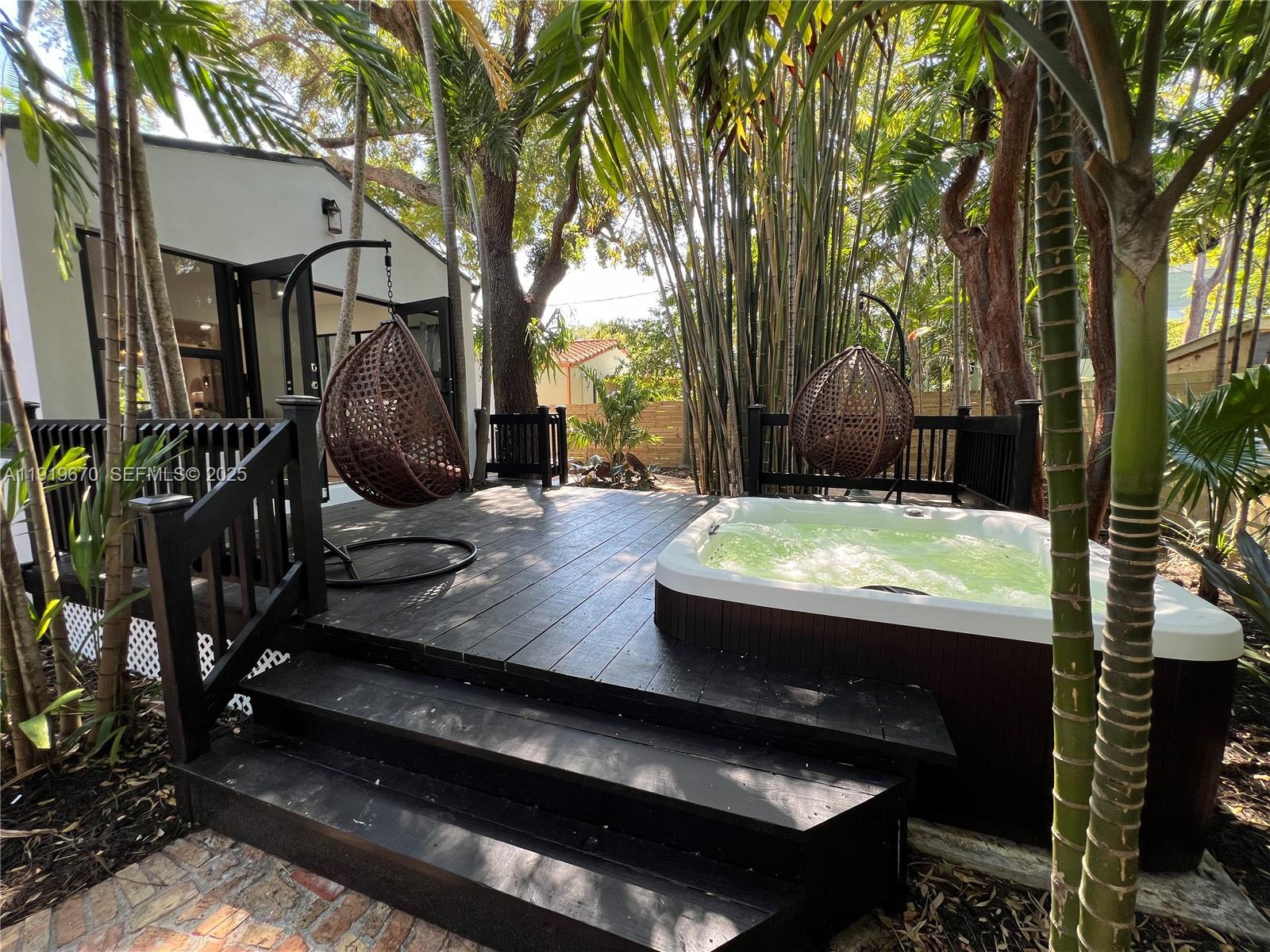 751 Northeast 80th Street Miami, FL 33138 - Photo 12 of 32 a view of swimming pool with seating area and trees around