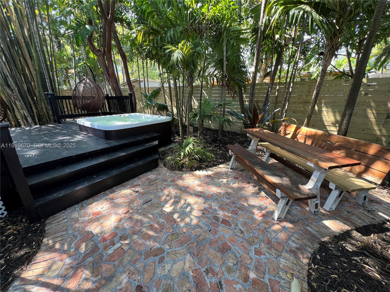 751 Northeast 80th Street Miami, FL 33138 - Photo 14 of 32 a view of a backyard with sitting area