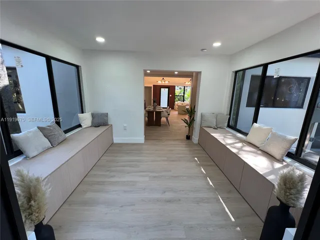 a living room with furniture and large windows