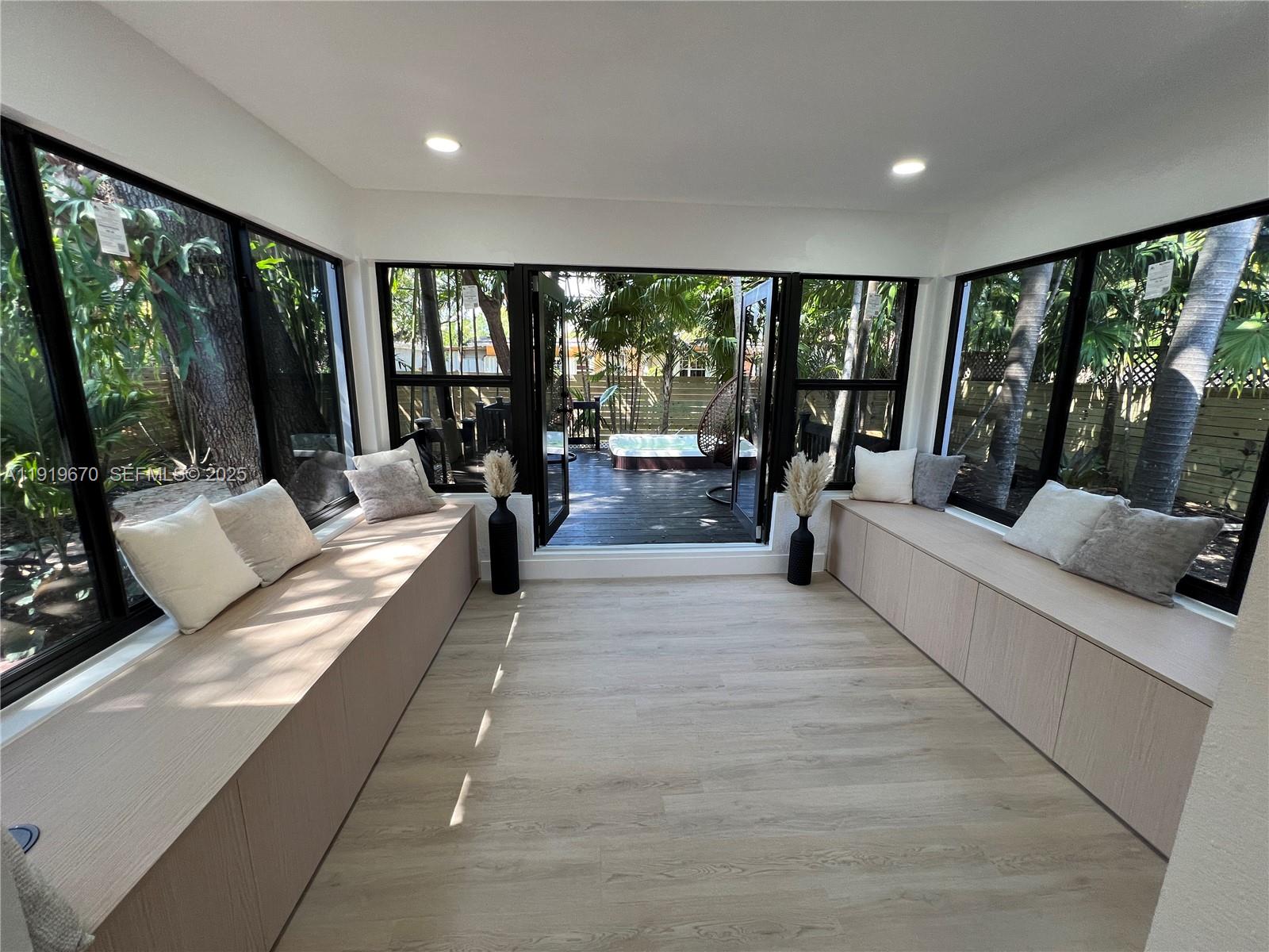 751 Northeast 80th Street Miami, FL 33138 - Photo 18 of 32 a living room with furniture and large windows