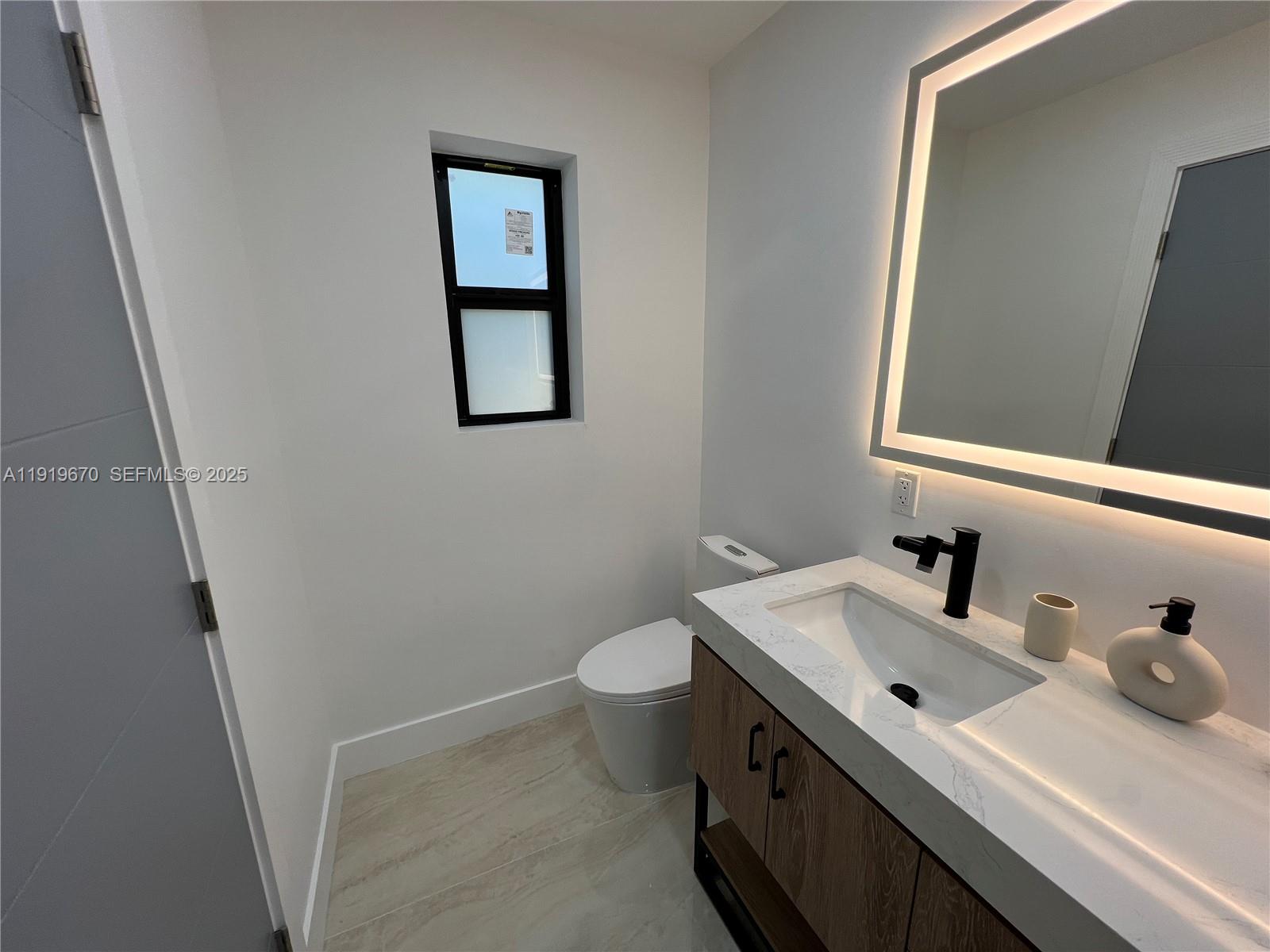 751 Northeast 80th Street Miami, FL 33138 - Photo 21 of 32 a bathroom with a sink and a toilet