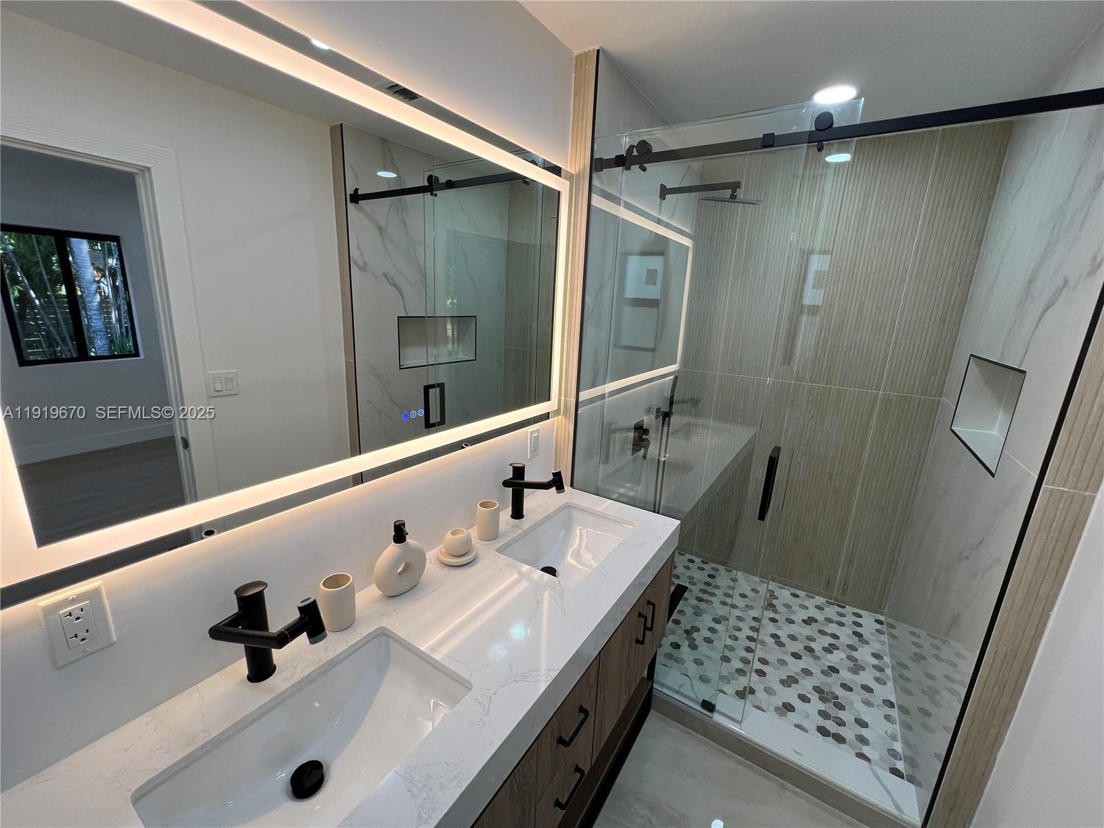 751 Northeast 80th Street Miami, FL 33138 - Photo 22 of 32 a bathroom with a sink mirror and shower
