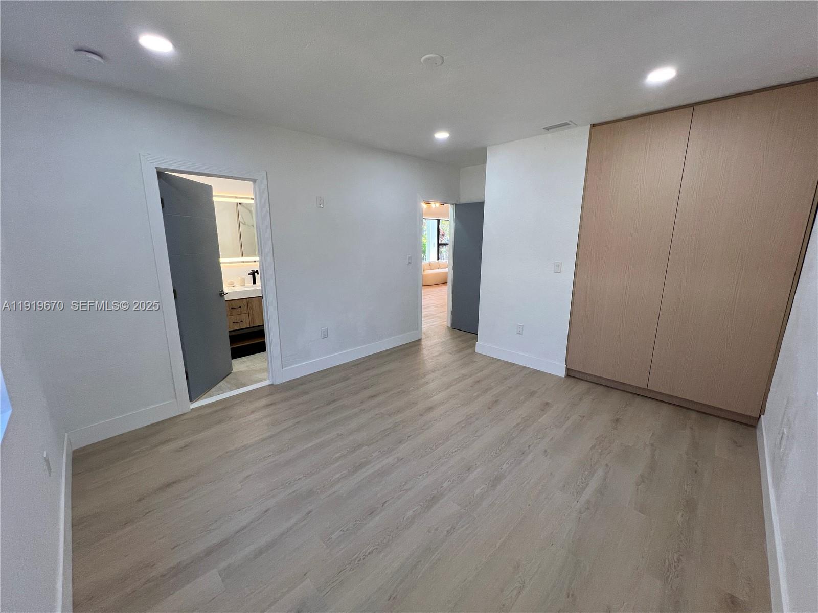751 Northeast 80th Street Miami, FL 33138 - Photo 23 of 32 an empty room with wooden floor and windows