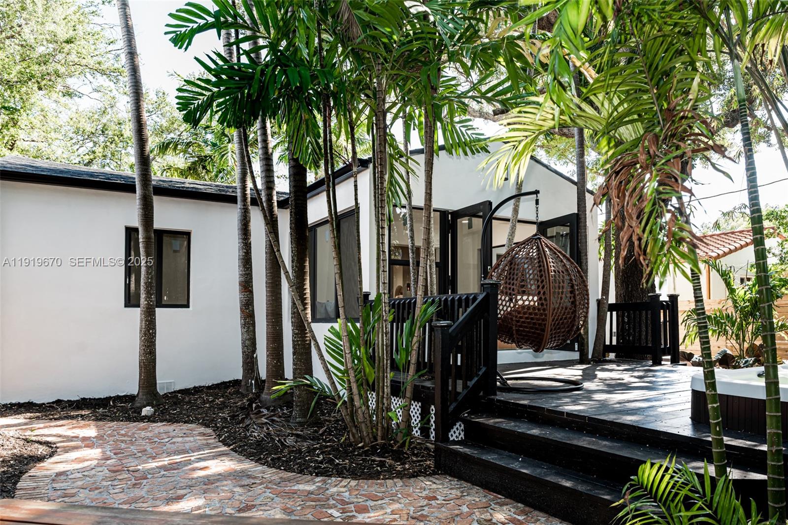 751 Northeast 80th Street Miami, FL 33138 - Photo 28 of 32 a view of a entrance gate of the house and trees