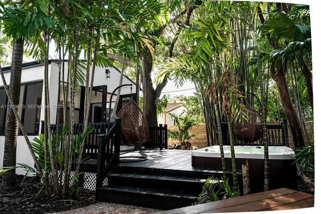a view of a chairs and fire pit in a backyard