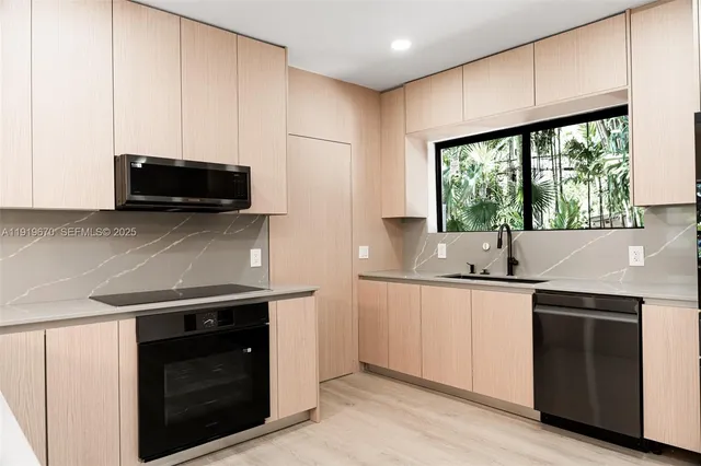 a kitchen with stainless steel appliances a stove sink and microwave