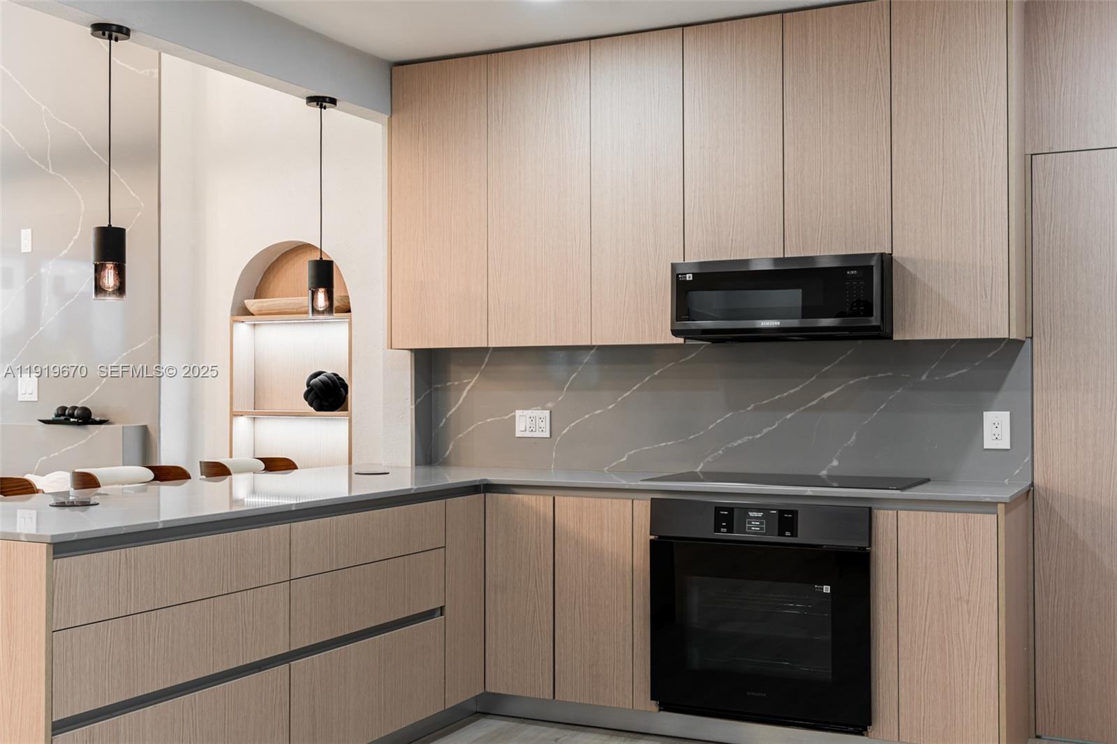 751 Northeast 80th Street Miami, FL 33138 - Photo 5 of 32 a kitchen with stainless steel appliances a stove a sink and a microwave