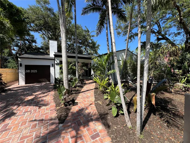 a large kitchen with stainless steel appliances granite countertop a stove a sink and a microwave