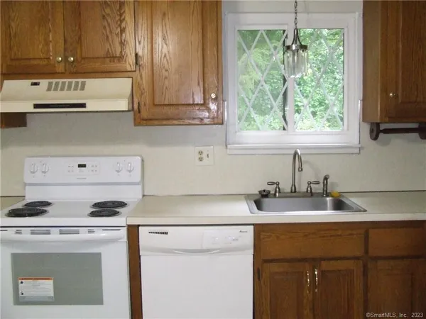 a kitchen with appliances cabinets and a window
