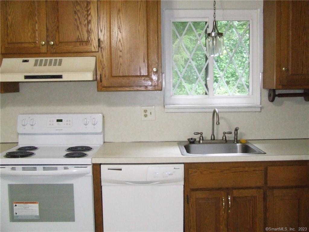 a kitchen with appliances cabinets and a window