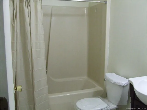 a bathroom with a shower and a toilet