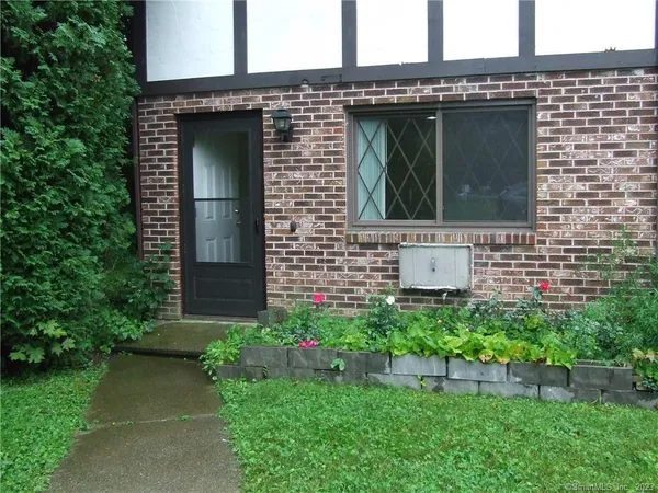 a view of house with backyard space and garden