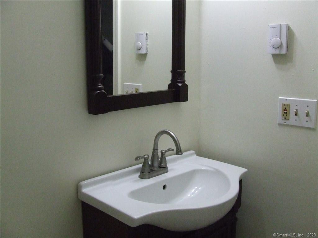 2 Branch Road, Unit 6A Thomaston, CT 06787 - Photo 19 of 19 a bathroom with a sink and a mirror