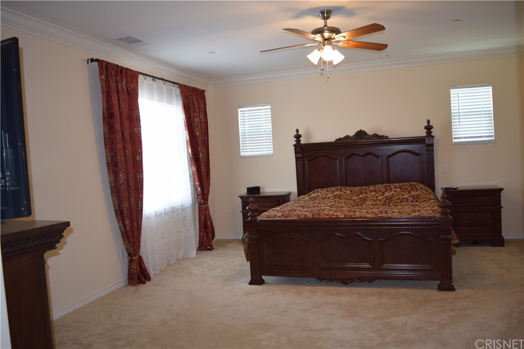26500 Township Street Saugus, CA 91350 - Photo 11 of 20 a bedroom with a bed and a chandelier