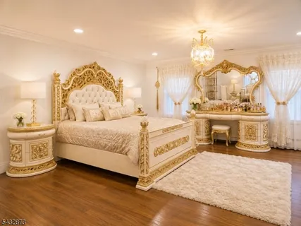 a spacious bedroom with a bed and a chandelier