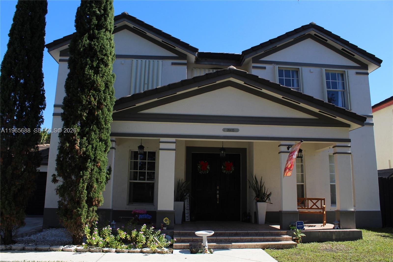 a front view of a house with garden