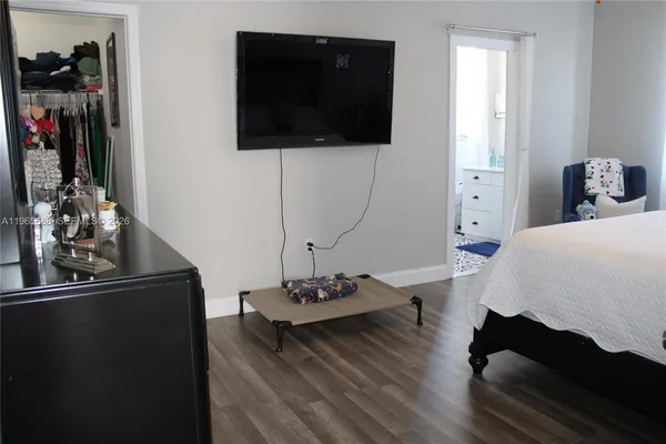 a bedroom with a bed and a tv