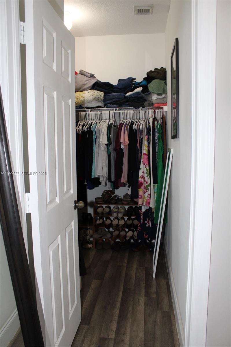 20135 Southwest 129th Avenue Miami, FL 33177 - Photo 12 of 54 a view of walk in closet with clothes and shoes