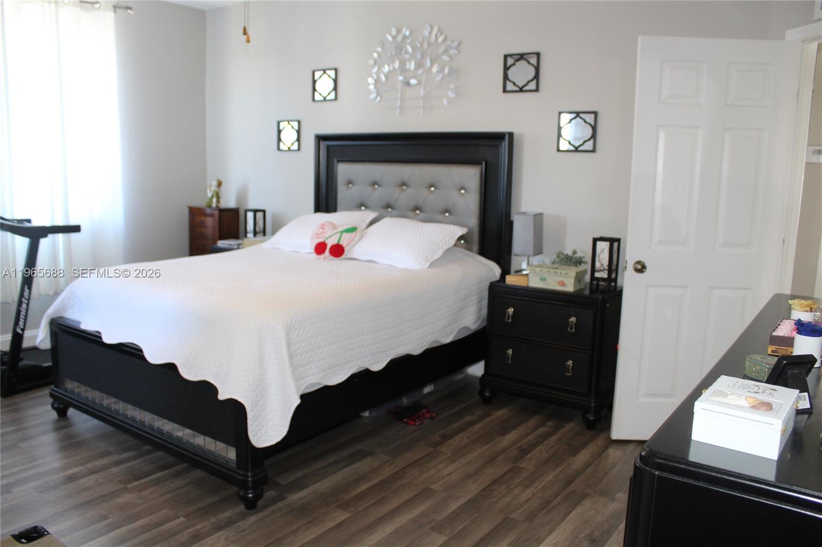 20135 Southwest 129th Avenue Miami, FL 33177 - Photo 13 of 54 a bedroom with a bed and a tv