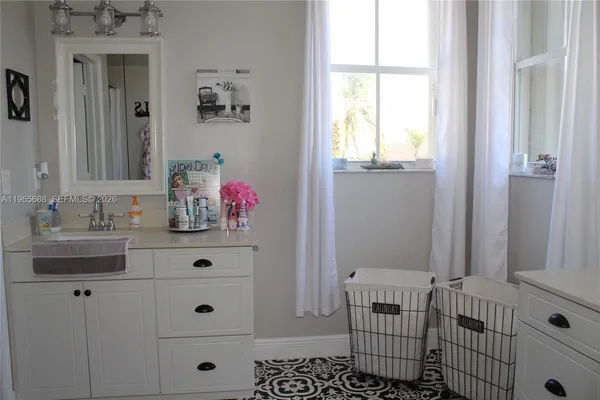 a bathroom with a sink a vanity and a mirror