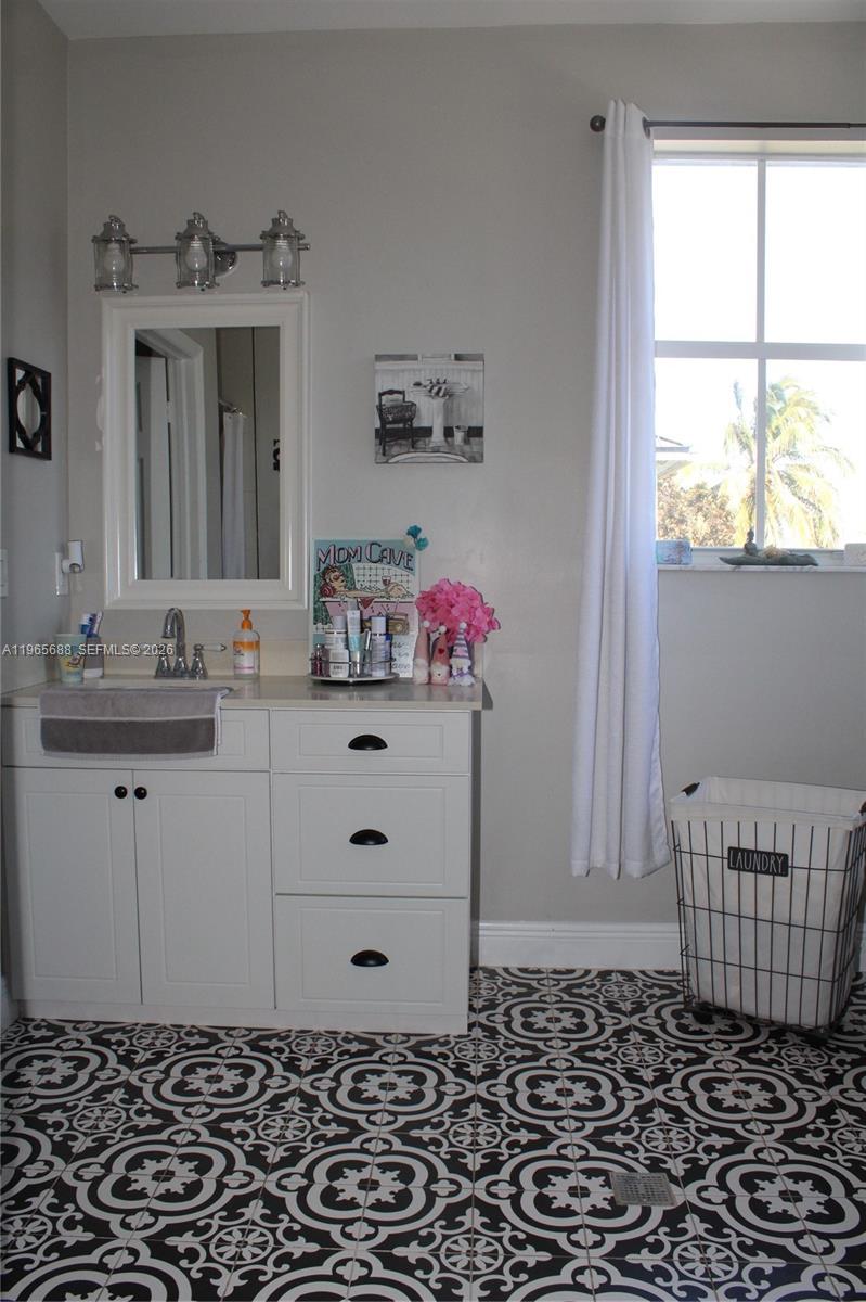 20135 Southwest 129th Avenue Miami, FL 33177 - Photo 17 of 54 a bathroom with a sink a vanity and a mirror