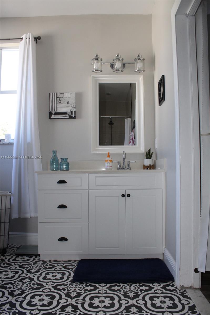 20135 Southwest 129th Avenue Miami, FL 33177 - Photo 19 of 54 a bathroom with a sink and a mirror