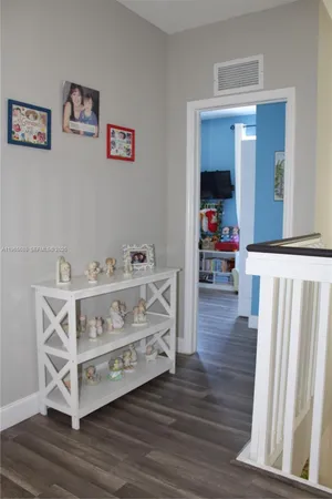 a bedroom with baby toys and dresser