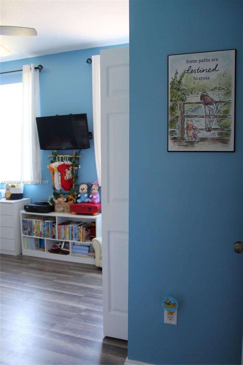 20135 Southwest 129th Avenue Miami, FL 33177 - Photo 21 of 54 a living room with furniture and a flat screen tv
