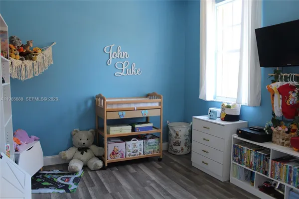 a view of a hallway with wooden floor and entryway